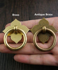 4 Pack Brass Drawer Pulls Antique Brass Cabinet Ring Handles With Mounting Screws 1.89 by 1.69 Inches shown on hand