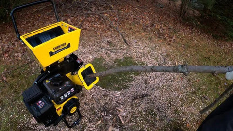 Heavy-Duty 3 Inch Portable Chipper Shredder With Collection Bag And 224cc OHV Engine For Fast Yard Cleanup Handles Branches Up To 3 Inches Gas Powered Easy Mobility processing a branch outdoors