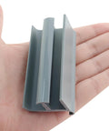 Grey PVC Sliding Shower Door Bottom Track For 7/16 Inch And 5/16 Inch Glass Thicknesses, Durable Moisture-Resistant Rail With Grey Finish, shown on hand.