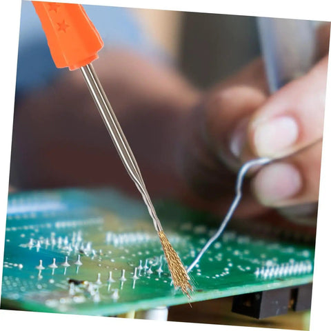 Close-up of Six Piece Soldering Assist Set Desoldering Pump And Wick Kit For PCBs with hands working on a circuit board.