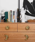 Sun Moon Cabinet Knobs Set, Solid Brass Antique Finish Drawer Pulls on dresser with decor and books in background