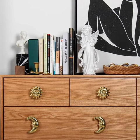 Sun Moon Cabinet Knobs Set, Solid Brass Antique Finish Drawer Pulls on dresser with decor and books in background