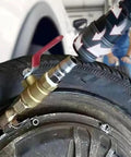 Close-up of Straight Up Slick Lock On Tire Inflator Chuck Quick Release Valve attached to a tire valve for easy inflation.
