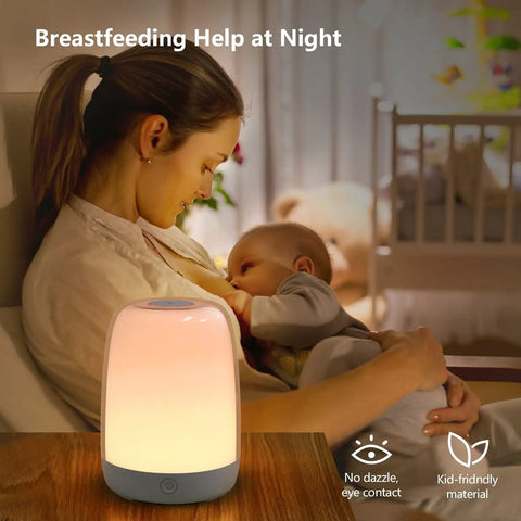 Nursery Night Light For Kids With Dimmable Warm White Glow And 5 Color Changing Modes placed on table during breastfeeding