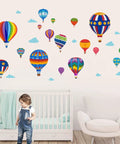 Hot Air Balloon Wall Decals For Kids Adventure Stickers For Bedroom Classroom Playroom Nursery Wall Art Decor Removable Peel And Stick Easy DIY Decor For A Fun Colorful Space displayed above a crib and a child