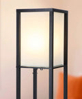 Close-up of Maxwell Shelf Floor Lamp with USB Ports, Wireless Charging Pad, and Built In Outlet, black frame and frosted glass shade.