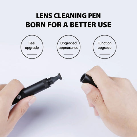 Front view of black VSGO Professional Lens Cleaning Pen with cap off, brush end visible, held by hands.