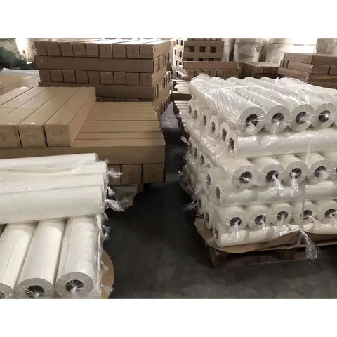 Fast Dry Dye Sublimation Paper Roll 95gsm 24x164ft for heat transfer printing stacked in warehouse, 2-inch core visible
