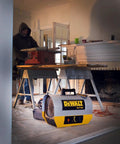 Heavy Duty 10 Kilowatt Forced Air Electric Construction Heater in use on a job site with a worker at a wood cutting table.