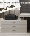 Leaf Shape Drawer Pull Handle Set In Vintage Bronze Finish shown on modern dresser with twig branch design, made in zinc alloy.