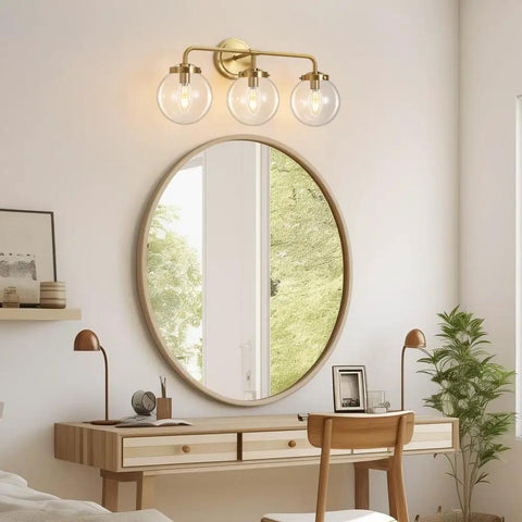 Three Light Vanity Wall Sconce Over Mirror In Matte Gold Finish With Transparent Glass Ball Shade, up in home office
