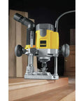 Pro Grade Workhorse Two Horsepower Plunge Router With Slick Ten Amp Electronic Variable Speed Motor in action trimming wood.
