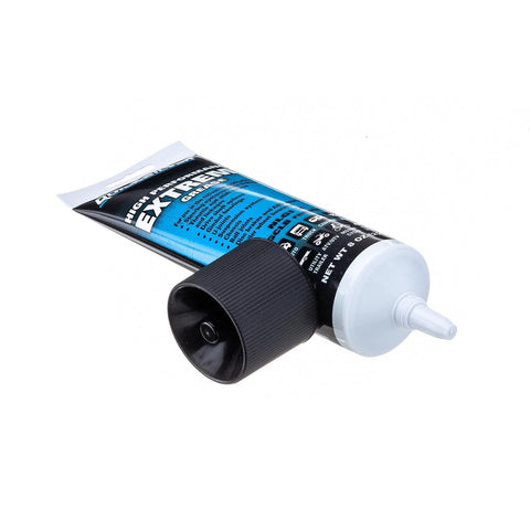 Quicksilver marine grease tube, side view, 8 oz, blue label, gray dispensing nozzle, black cap.