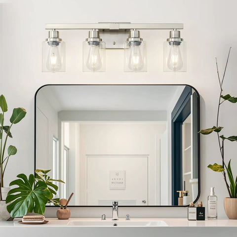 Four Light Brushed Nickel Bathroom Vanity Light With Clear Glass Shades above mirror in modern bathroom setting