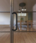 Aluminum Pull Handle 10 Inch Length, 9 Inch Center To Center, 1 Inch Diameter, Matte Black Finish on glass door