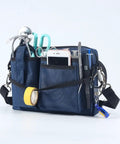 Heavy Duty Utility Waist Pack With Modular Tool Dividers And Waterproof Zippers For Job Site Hustlers Seeking Kick Ass Storage For Drill Bits Pliers And Pro Gear Built Tough As Nails Every Single Shift filled with tools, scissors, and tape, showing durable material and multiple pockets.