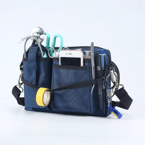 Heavy Duty Utility Waist Pack With Modular Tool Dividers And Waterproof Zippers For Job Site Hustlers Seeking Kick Ass Storage For Drill Bits Pliers And Pro Gear Built Tough As Nails Every Single Shift filled with tools, scissors, and tape, showing durable material and multiple pockets.