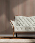 Fresh Peach Floral Stripe and Silver Metallic Wallpaper Bring Sick Textured Vibes to Any Room with This Eco Friendly Paste The Wall Accent Covering Made in USA and Completely PVC Free, displayed behind a cream tufted couch.