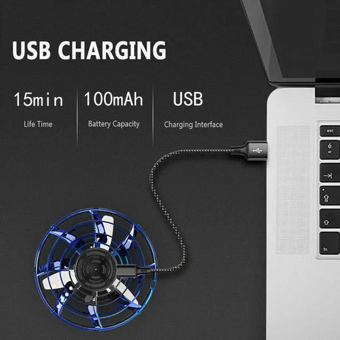 Flying Spinner UFO Drone Hand Controlled Mini Fidget Toy charging via USB on a laptop, highlighting easy USB charge feature.