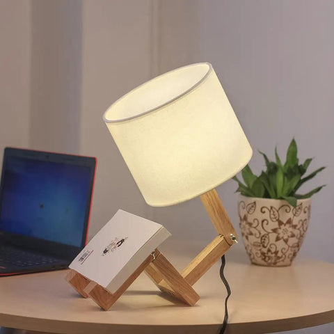 Cute Desk Lamp With Wood Base And Changeable Shape, ivory linen lampshade, on table beside plant and laptop, cozy vibe