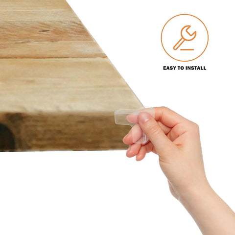 Hand holding clear PVC corner protector from 16 pack for furniture and cabinets, easy install safety corner guards with cushioned edges.