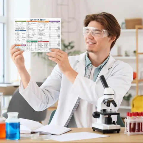 6x9 Laminated Periodic Table Poster For Classrooms And Study Spaces held by a student in a chemistry lab setting.