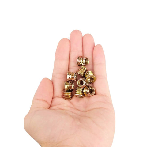 Hand holding 40Pcs 1/4-20 X 10mm Wood Threaded Inserts Fastener Kit With Hex Socket Drive And 6mm Hex Spanner For Furniture DIY Repairs