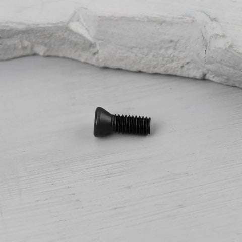 Premium M3.5 X 10 Millimeter Torx Drive Screws For Cnc Lathe Tool Holders And Carbide Inserts Rock Solid Class Twelve Point Nine Carbon Steel With Black Coating Tough As Nails Machining Fasteners Twenty Pack on a wooden surface.