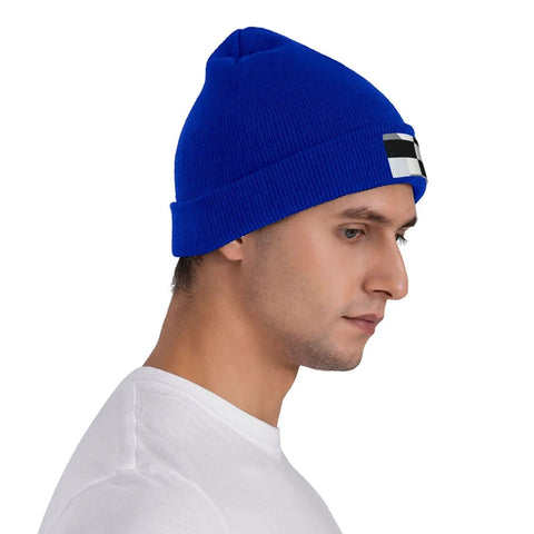 Kick Cold Weather To The Curb With This Straight Up Cozy Black And White Piano Plate Grid Knit Hat Crafted From Ultra Plush Acrylic Fiber For No Cap Winter Warmth Indoors Or Stepping Outside, blue knit beanie worn by man.