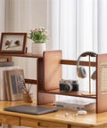 Expandable Bamboo Bookshelf Organizer For Your Home Office with books and decor on a wooden desk.