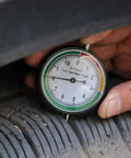 Slick Stainless Steel Tire Tread Depth Gauge Delivering Dead On Accuracy For Quick Rubber Wear Checks being used on tire.