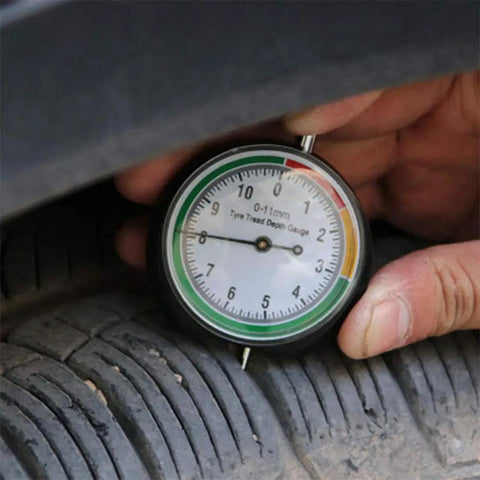 Slick Stainless Steel Tire Tread Depth Gauge Delivering Dead On Accuracy For Quick Rubber Wear Checks being used on tire.