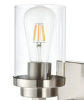 Close-up of Three Light Vanity Light Fixture In Brushed Nickel With Clear Glass Shades For Modern Bathrooms