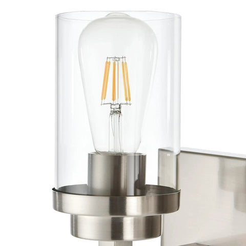 Close-up of Three Light Vanity Light Fixture In Brushed Nickel With Clear Glass Shades For Modern Bathrooms