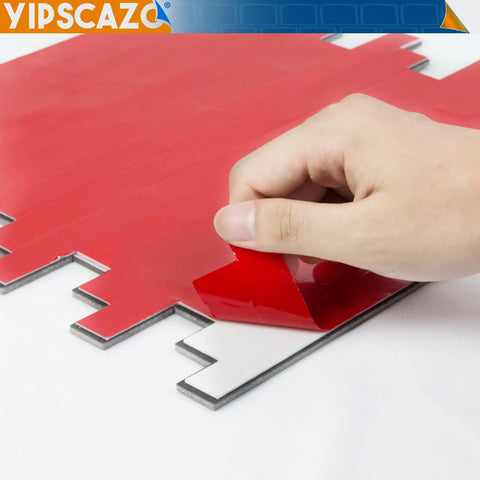 Hand peeling adhesive liner from Peel And Stick Stone And Metal Tile Backsplash For Kitchen Bathroom And Fireplace 10 Sheets In Bright Carla White