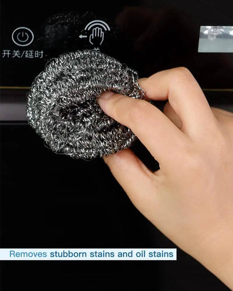 Hand using Heavy Duty Stainless Steel Scrubber Pad on oven surface, 2.4 inch ergonomic, durable spiral wire, 12 pack, rust-resistant.