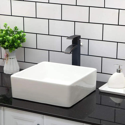 Square Bathroom Vessel Sink Porcelain Ceramic White Vanity Sink Above Counter Modern Sink For Cabinet Lavatory Hotel Style Art Basin Home Washing Basin No Fuss Easy Clean Glaze Finish Sleek Look in modern bathroom setting with black countertop and white subway tile backdrop.