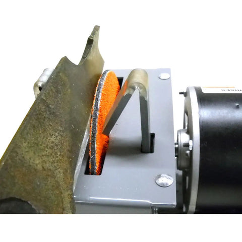 Close-up of Heavy Duty 7 Inch Arc Lawnmower Blade Bench Grinder With Half Horsepower Motor sharpening a mower blade.