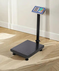 Heavy Duty Shipping Scale With 660 Pound Capacity Foldable Digital Platform Absolute Breeze For Luggage And Postal Packages on wooden floor.