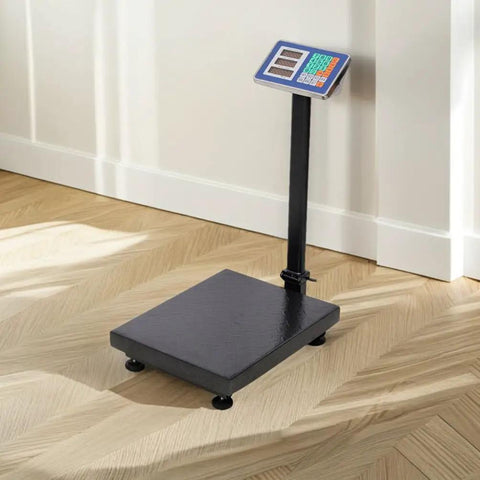 Heavy Duty Shipping Scale With 660 Pound Capacity Foldable Digital Platform Absolute Breeze For Luggage And Postal Packages on wooden floor.