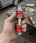 Pair Front Sway Bar Link Kit For Toyota Echo Scion Xa Xb Acura Integra held showing heavy duty red bushings and metal parts.