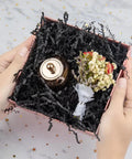 Hassle Free Black Crinkle Cut Paper Shred Filler For Gift Baskets And Boxes Smooth Cushion Wrapper in a gift box with decor.