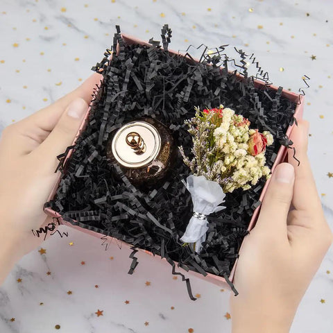 Hassle Free Black Crinkle Cut Paper Shred Filler For Gift Baskets And Boxes Smooth Cushion Wrapper in a gift box with decor.
