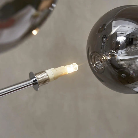 Close-up of bulb socket and smoky grey glass globe on Sputnik 4 Light Floor Lamp with chrome finish.