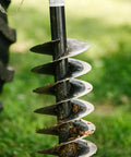 Close-up of a 9 inch auger from a rear mounted 30 HP 3 point post hole digger with dirt, designed for Cat 1 tractors.