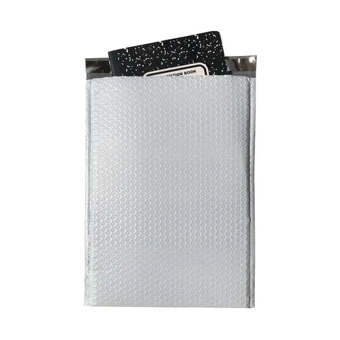 25 Count Large Poly Bubble Mailers 10.5 Inch By 15 Inch Bubble Lined Cushioned Self Seal Shipping Envelopes shown with notebook