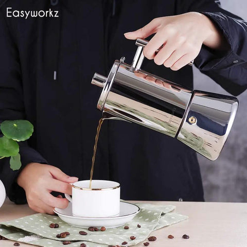 Heavy Gauge Stainless Steel Stovetop Espresso Maker And Legit Italian Moka Pot For 4 Cups pouring coffee into a cup.