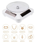 Ipetboom Battery Free Rotating Display Stand Electric Jewelry Showcase Solar Powered Turntable with clear acrylic top and white base.