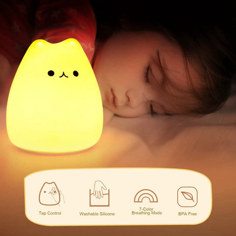 LED Cat Night Light For Kids Battery Powered Silicone Cat Nursery Night Light With 2 Soft Glow Modes next to sleeping child