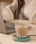 Smart Electric Coffee Mug Warmer Triple Temperature Settings Digital Display keeping coffee warm on desk next to laptop.